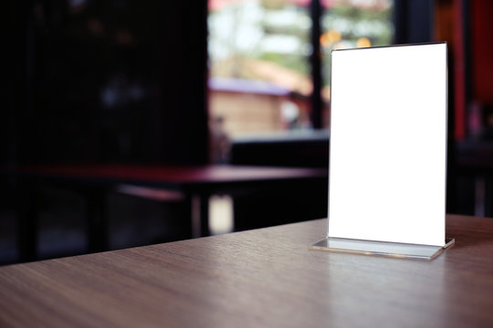 Close-up Of Blank Placard On Wooden Table In Restaurant