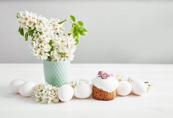 Easter sweet bread, Easter cake with flowers and gingerbread. Holidays breakfast concept with copy space. Easter greeting card template. Homemade pasques.Easter sweets on white background.