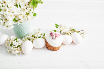 Easter sweet bread, Easter cake with flowers and gingerbread. Holidays breakfast concept with copy space. Easter greeting card template. Homemade pasques.Easter sweets on white background.