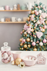 Christmas sweets on background of Christmas tree. Pink decorated christmas. Happy New Year!Traditional New Year dessert. Copy space. Greeting card, calendar template.Christmas Kitchen Decoration