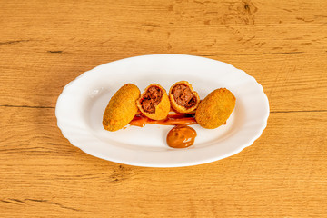 chocolate-filled croquettes on wooden table