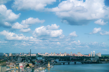 Sky with fluffy clouds over city in summer, Kiev, Ukraine. Cityscape.