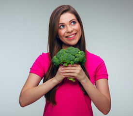 Woman in red dress holding green broccoli.