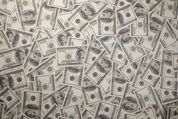 Group of money stack of 100 US dollars banknotes a lot of the background texture top view