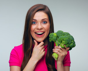 Healthy food dieting with smiling woman holding green broccoli.