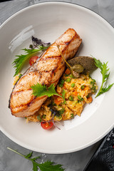 grilled salmon dish. grey backgroound