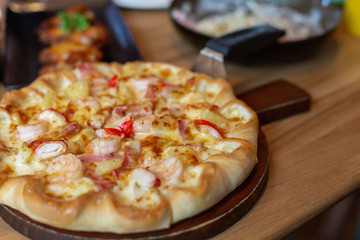 Seafood Italian Pizza slice on wood dish