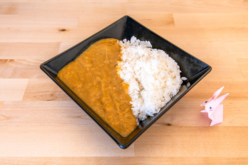 chicken curry garnished with white rice