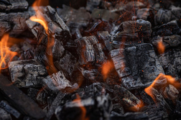 Background of burning hot coals. Burning coals in the brazier. Kindling the fire for the barbecue.