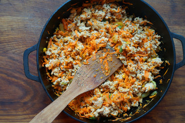 Cooking at home kitchen chicken meat side dish. Cook fry minced meat with vegetables.