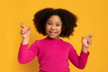 Cute Little Afro Girl Pleading For Something With Crossed Fingers