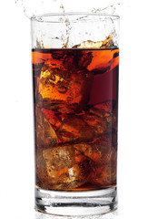 A tall glass with ice and refreshing cola like colored drink.