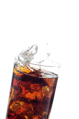 A tall glass with ice and refreshing cola like colored drink.