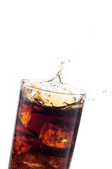 A tall glass with ice and refreshing cola like colored drink.