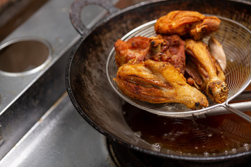 Fried chicken in hot oil and boiling in pan