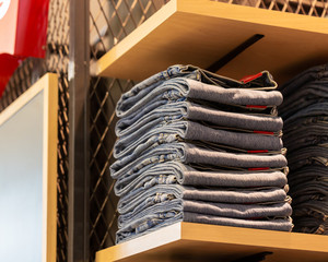 Jeans denim stacked with multiple waist sizes on shelves