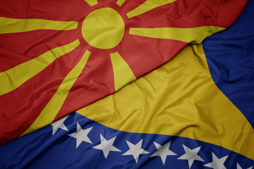 waving colorful flag of bosnia and herzegovina and national flag of macedonia.