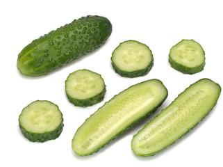 Cucumber and its slices in the corner isolated on a white background