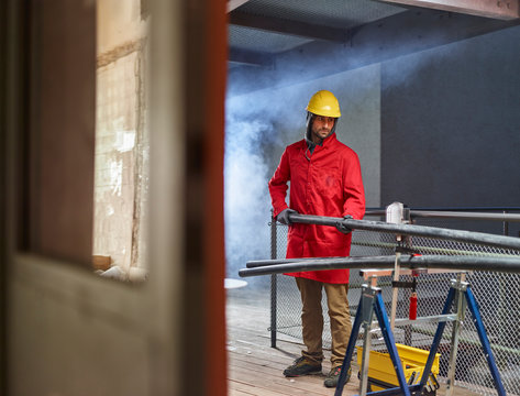 Installer preparing platic pipes on construction  site