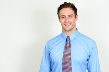 Portrait of happy young handsome businessman smiling