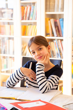 Portrait of smiling girl doing homework