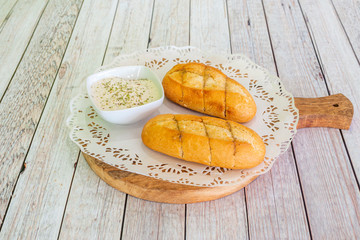 portions of garlic bread on wooden dish