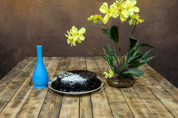 Moisture cake with topping chocolate, dry coconut with decoration on the wooden table, selective focus.