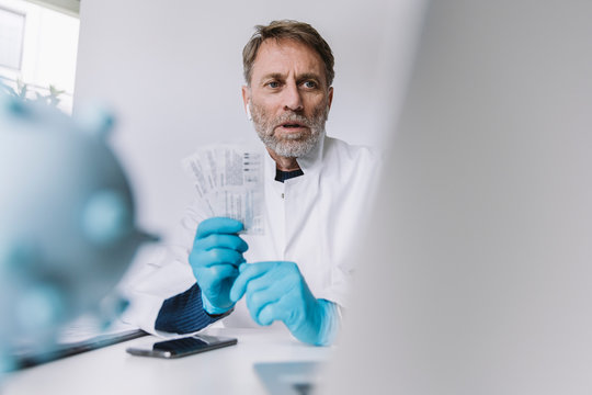 Scientist holding up lateral flow test device in video conference