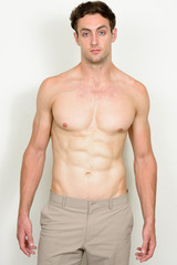 Fototapeta premium Portrait of young handsome muscular man shirtless