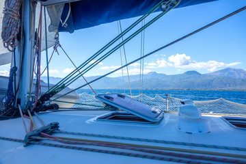 View of the Hilly Coast Through the Rigging of a Sailing Yacht