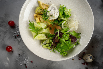 avocado, tomato and arugula salad. Healthy vegan food. Top view, square image