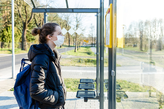 Portrait of a girl with mask waiting at bus stop