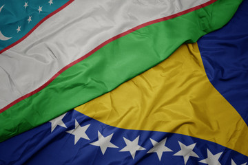 waving colorful flag of bosnia and herzegovina and national flag of uzbekistan.