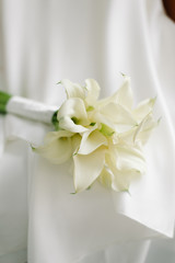 Fototapeta na wymiar A close up wedding bouquet, white calla lilies.