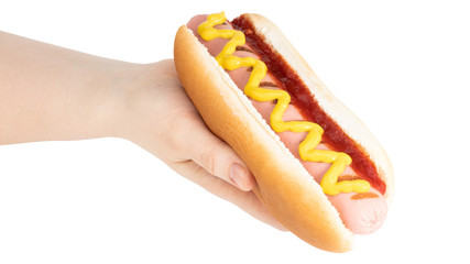 Hand holding hot dog with mustard isolated on white background. Clipping path
