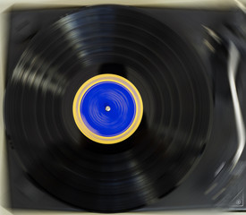 Vinyl Record Player with a spinning vinyl record.