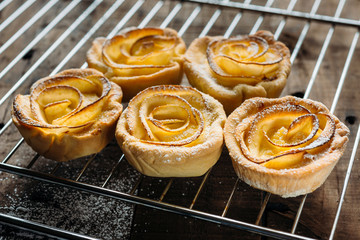 Pastries with custard decorated with apple slices in the shape of a rose