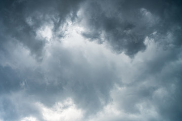 Fototapeta premium Background of beautiful dark clouds before a raining and thunder-storm. A dramatic sky with gray dense clouds. view from ground surface.sad feel.