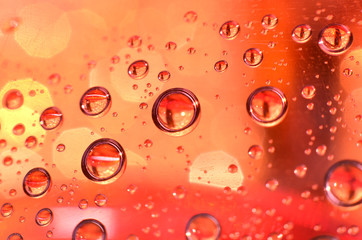 shiny clear water point attached to a glass reflects the same color as the color on the glass into a beautiful background as decoration