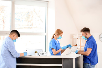 Fototapeta premium Female receptionist working with patients in clinic