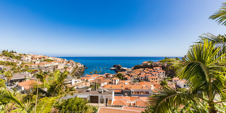 Portugal, Madeira, Camara de Lobos, Panorama of clear sky over coastal town in summer