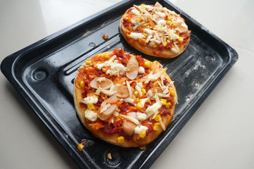 Mini Pizza with sausage, corn, carrot, cheese and Beef. Homemade mini pizza.                              