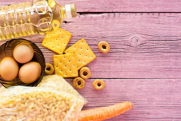 Food items on a pink wooden background. The concept of reserves.