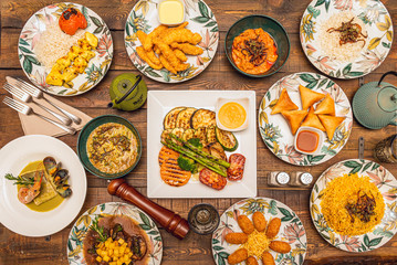 overhead shot of Persian food dishes on dark wooden table