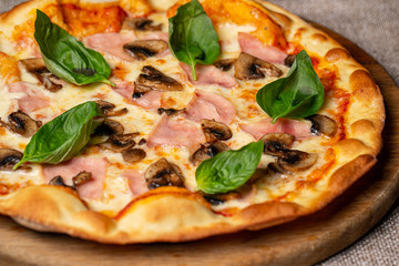 Pizza pepperoni, mozzarella, oregano on a black background