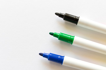 Several colored markers on a light background. Selective focus.