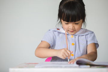 Little asian doing homework