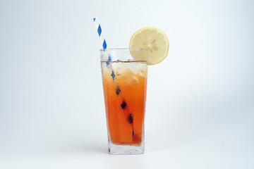 Ice lemon tea with ice cube yellow lemon slice blue white paper straw on white background