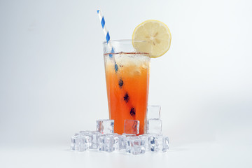 Ice lemon tea with ice cube yellow lemon slice blue white paper straw on white background