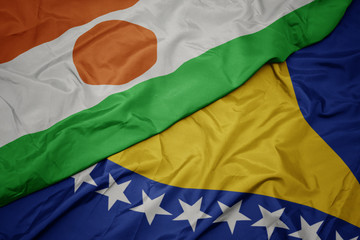 waving colorful flag of bosnia and herzegovina and national flag of niger.